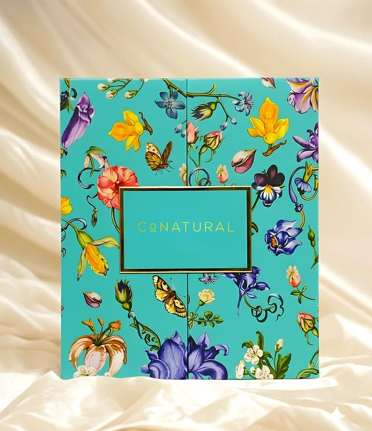 CoNatural teal floral gift box on cream silk