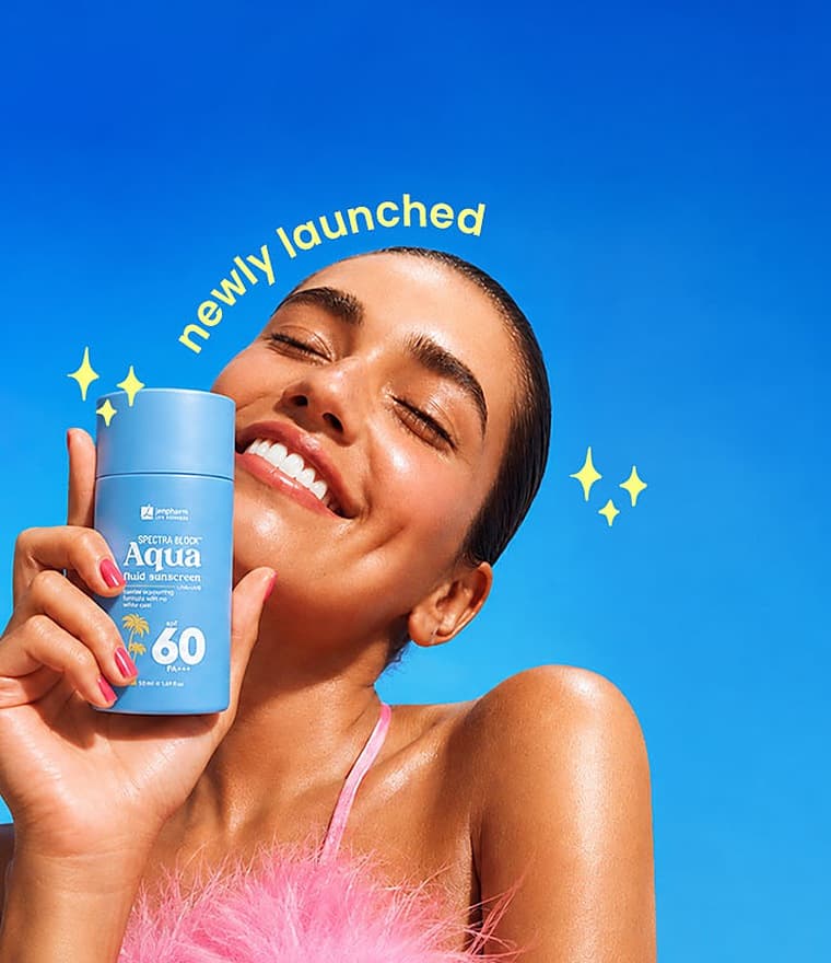 Spectra Block Aqua fluid sunscreen SPF 60 held up against a blue sky