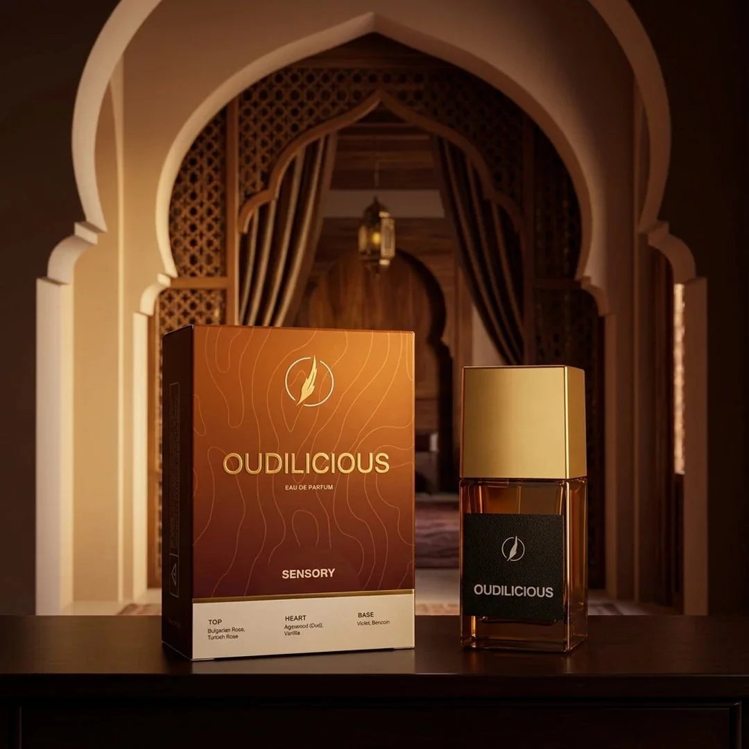 An Oudilicious perfume box and bottle under a carved arch