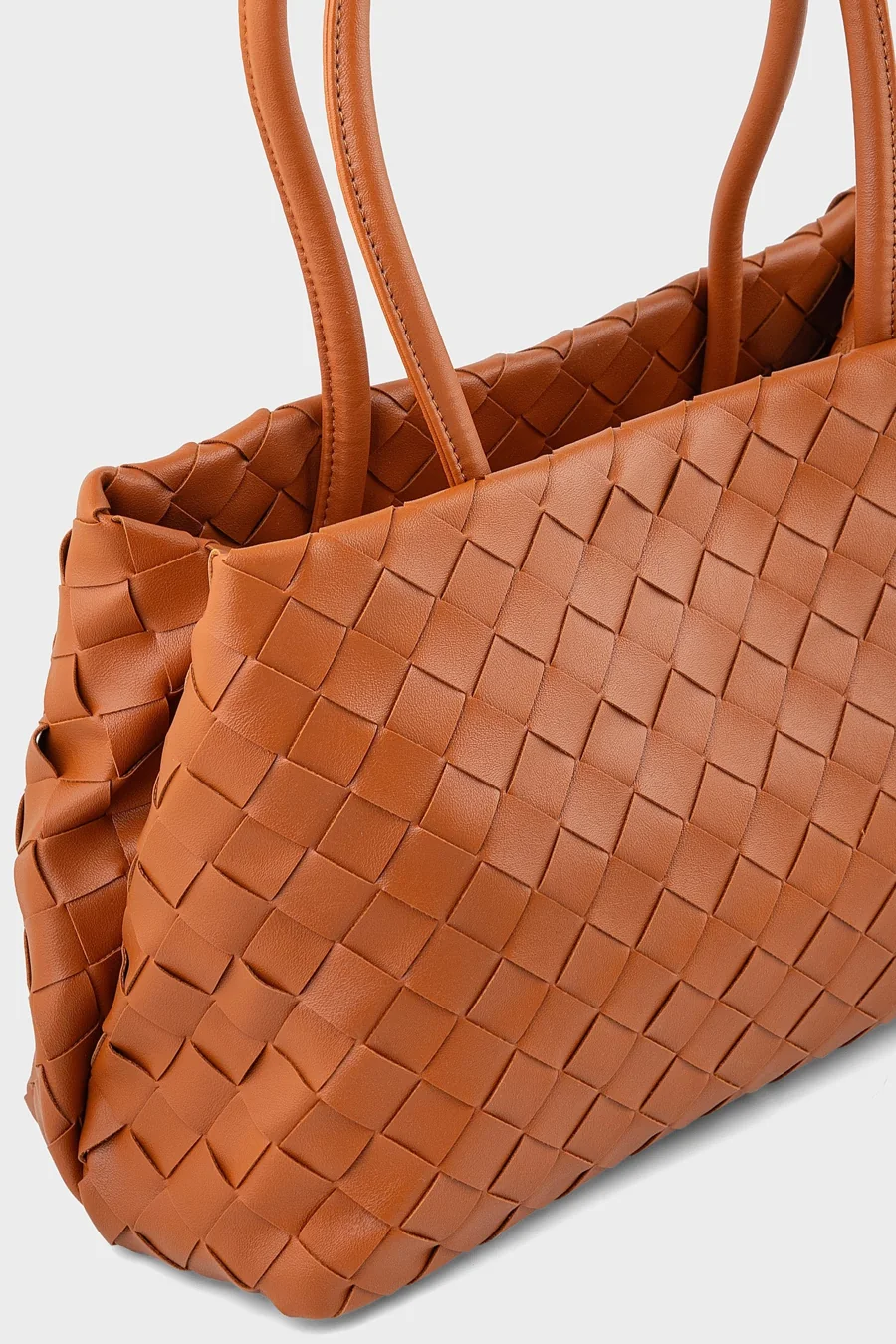 A tan woven leather shoulder bag
