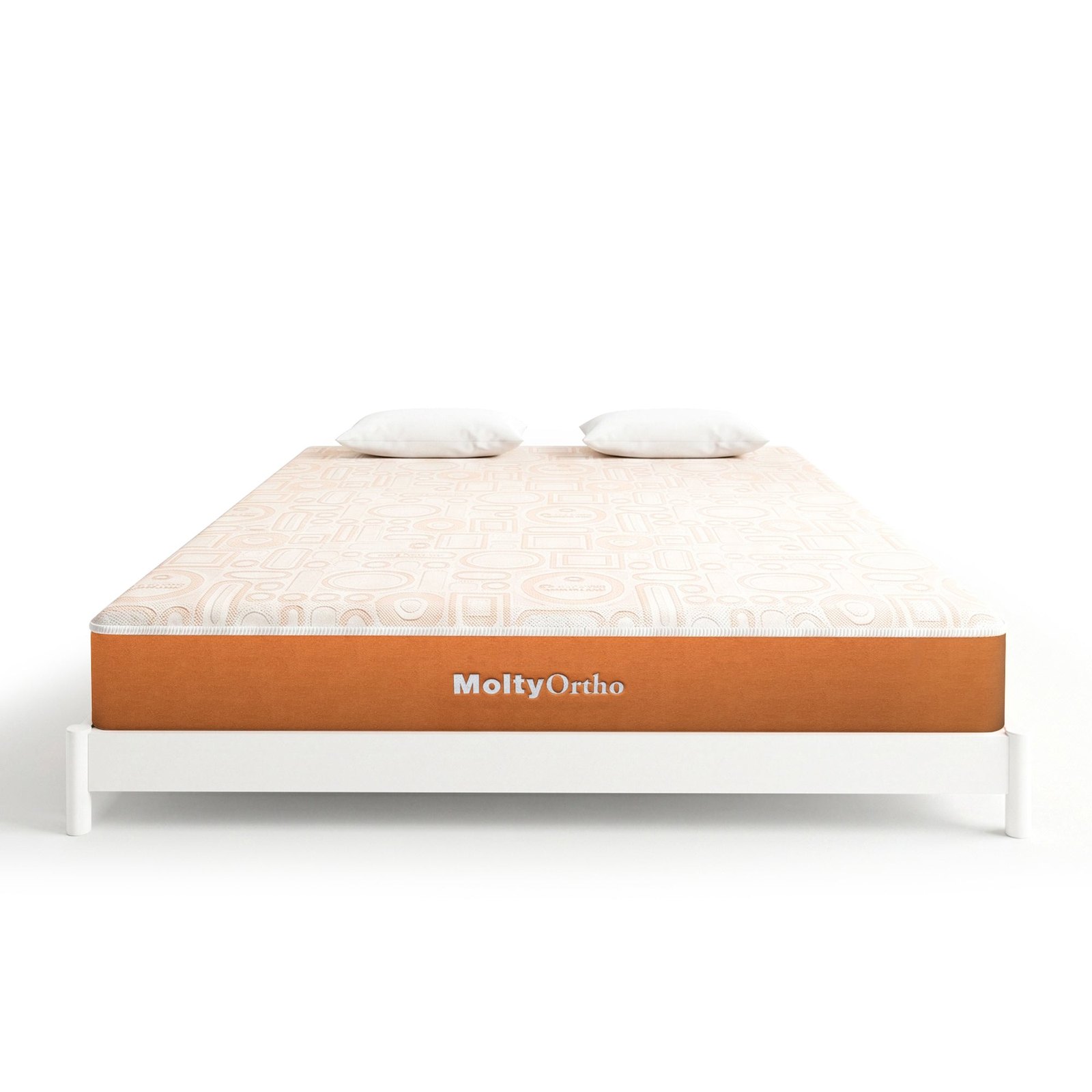 A MoltyOrtho mattress with two pillows on a white bed frame